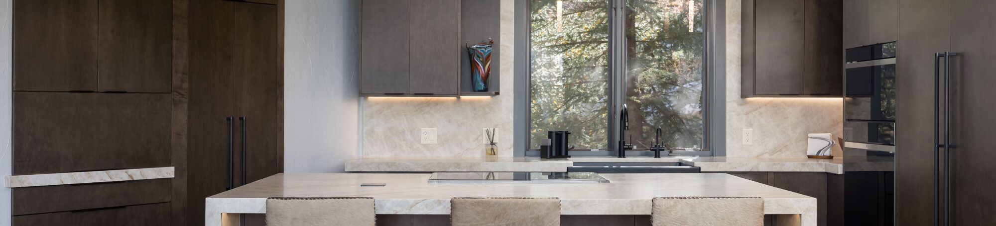 This is a picture of a kitchen featuring Bridgewood cabinets with Maple wood species and an iron stain.