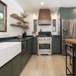 Modern kitchen featuring custom green cabinetry, a white farmhouse sink, sleek quartz countertops, and a stainless steel range, located in Breckenridge, Colorado.