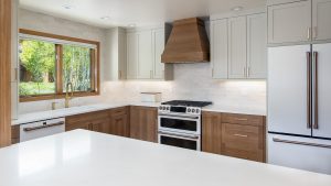 This kitchen design showcases Bespoke White Oak cabinetry paired with Accessible Beige painted upper cabinets, creating a timeless two-tone palette that’s built to endure