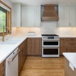 This is a picture of a kitchen featuring white oak and painted cabinetry.