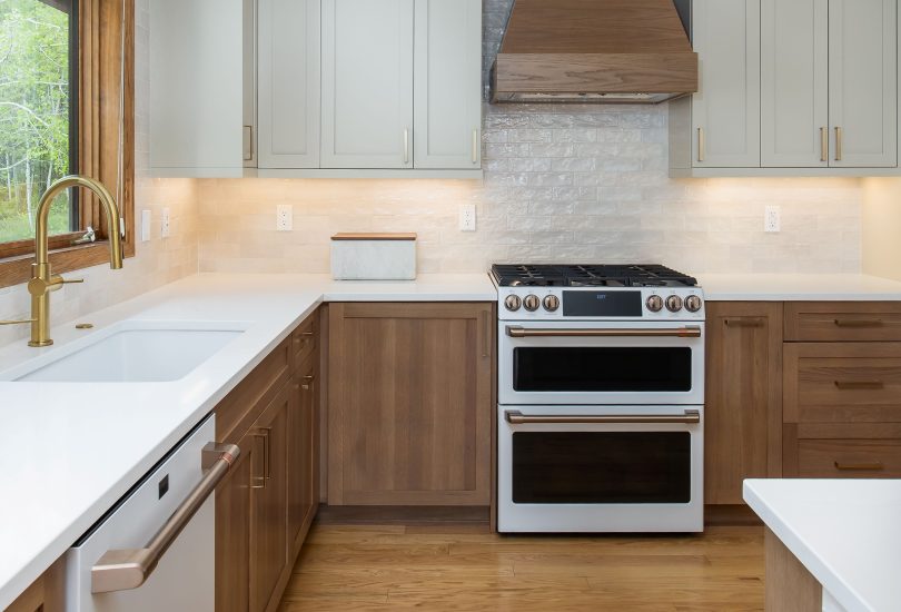 Cashmere Lower Cabinetry; Accessible Beige Uppers Kitchen Remodel by Creative Cabinetry project photo 3