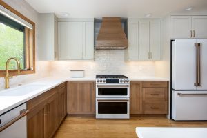 This kitchen design showcases Bespoke White Oak cabinetry paired with Accessible Beige painted upper cabinets, creating a timeless two-tone palette that’s built to endure