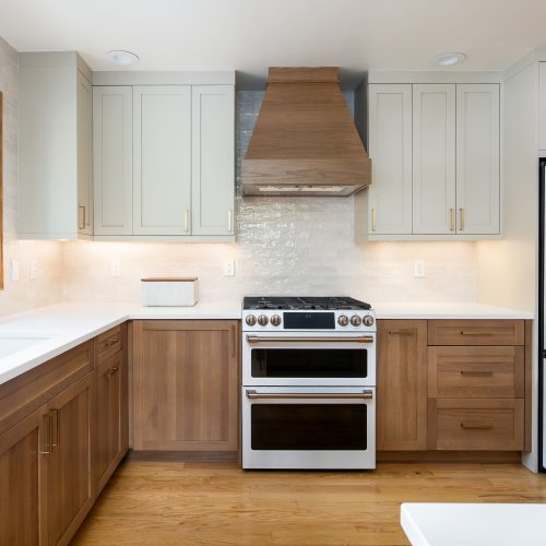 This kitchen design showcases Bespoke White Oak cabinetry paired with Accessible Beige painted upper cabinets, creating a timeless two-tone palette that’s built to endure