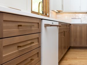 This is a picture of a kitchen featuring white oak and painted cabinetry.